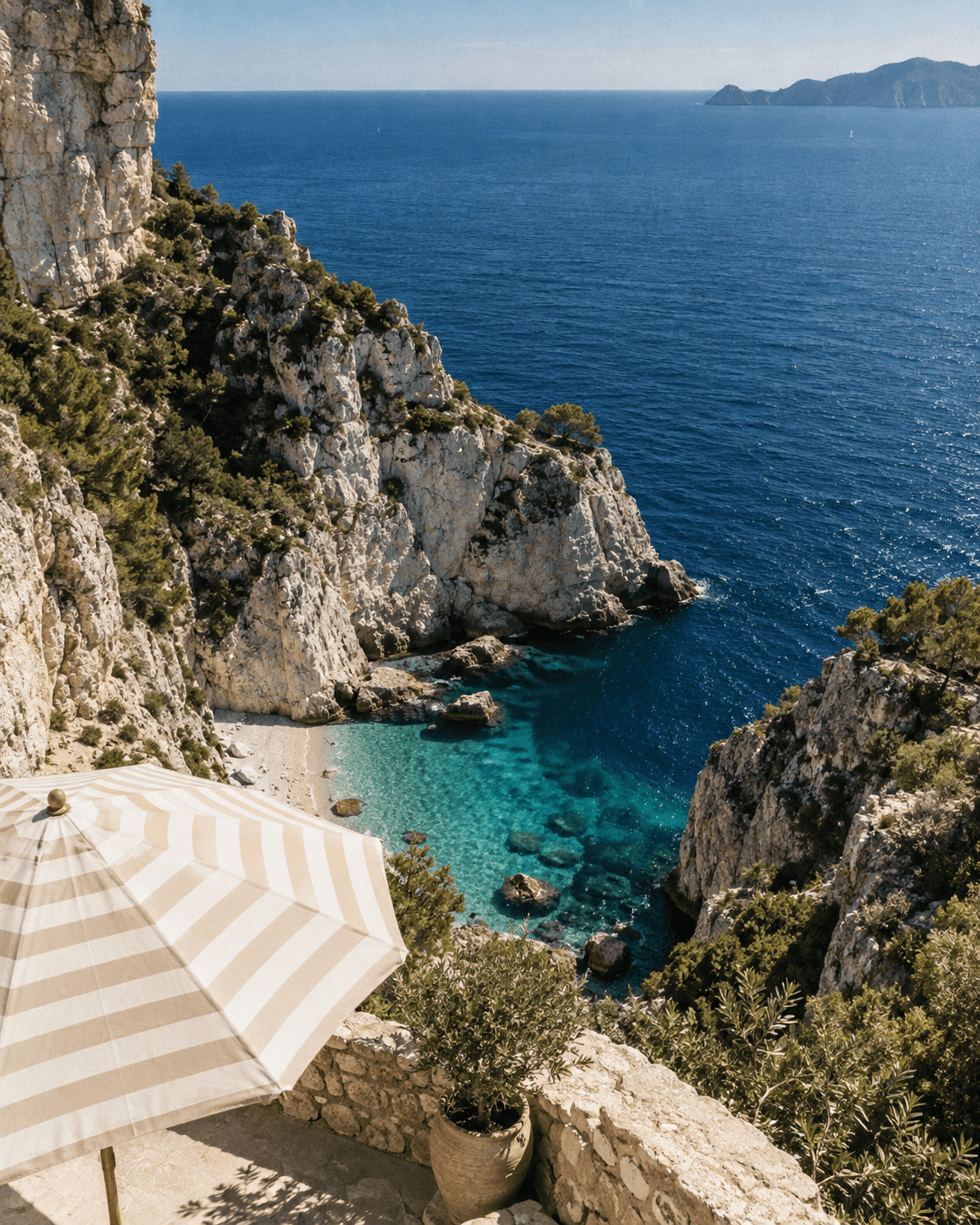 Sunlit Mediterranean cliffs above a turquoise cove